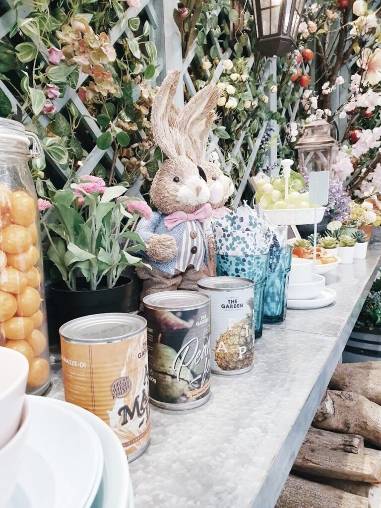 brown rabbit plush toy beside blue and white ceramic mug